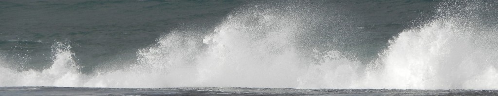 Waves spraying at coastal rocks
