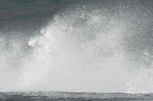 Waves spraying at coastal rocks